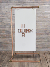 Load image into Gallery viewer, Copper Hanging Sign Stand For Barbers Shop, Salon, Cafe, Wedding Against Brick Wall, With Wooden Floor Boards