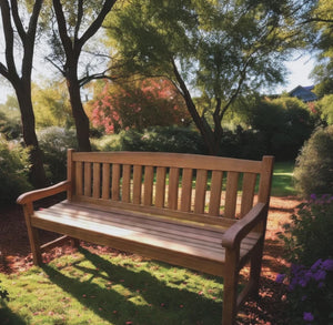 outdoor wood bench made from iroko wood in outdoor garden setting