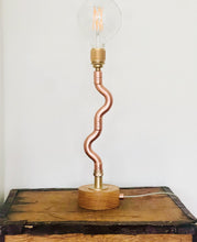 Load image into Gallery viewer, Handmade Copper pipe lamp with naked builb, oak base and quirky stem on an old tea chest