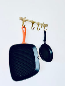 Brass Heavy Duty Kitchen Utensil Rail With Five Brass Hooks Holding Cast Iron Skillet And Frying Pan