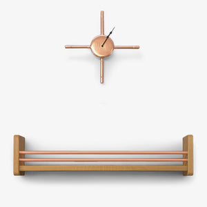 Handmade Copper Wall Clock With Black Hands Abiove A Solid Oak Shelving Unit With Copper Front Rails